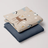 Dog Park muslin swaddle and navy blue blanket folded together